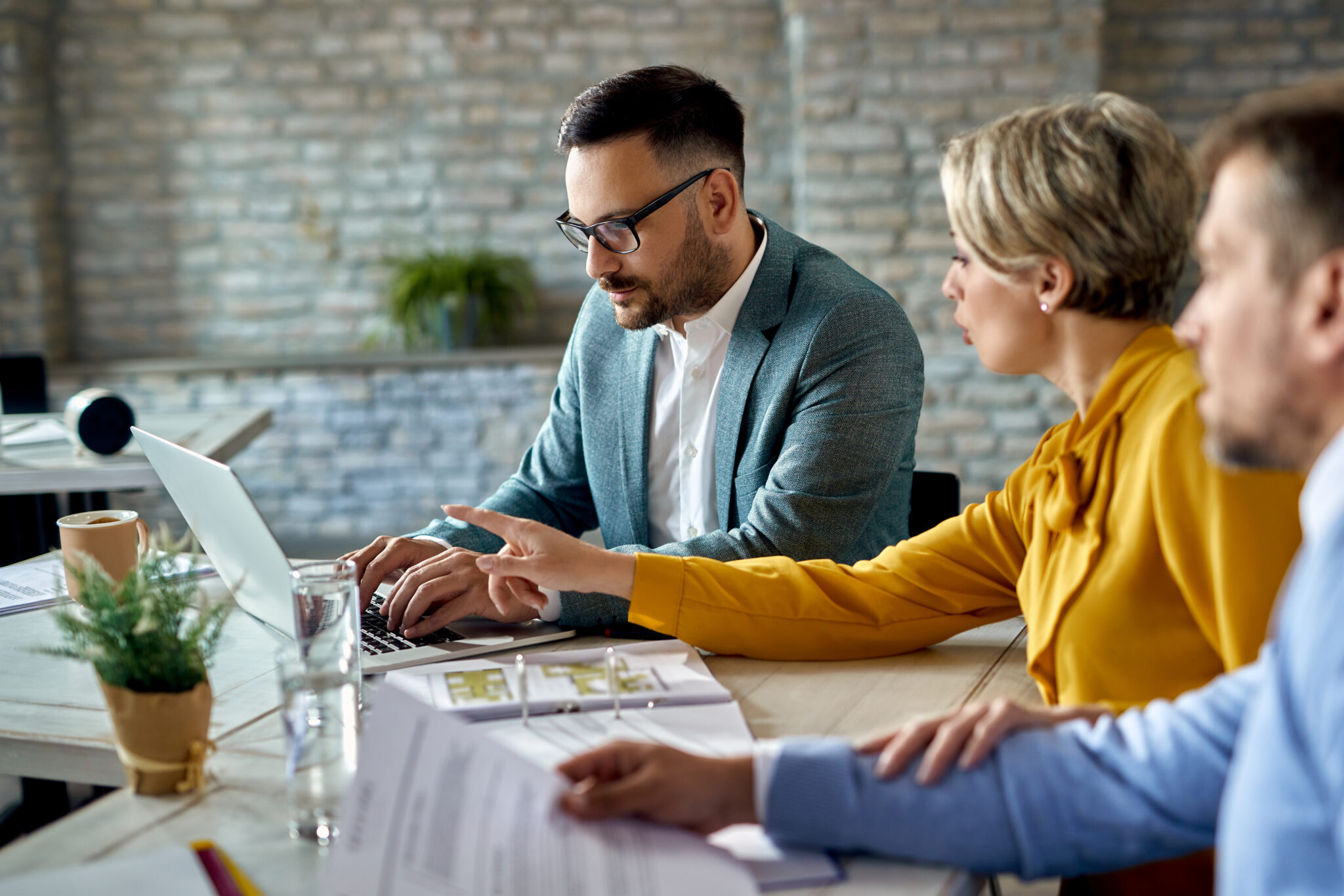 real estate agent using laptop while having a meeting with a cou
